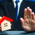 The,Man,Holds,The,House,And,Makes,A,Stop,Gesture.