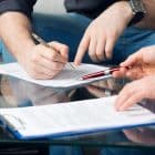 Hands,Of,Two,Men,Signed,The,Document,,Sitting,At,The